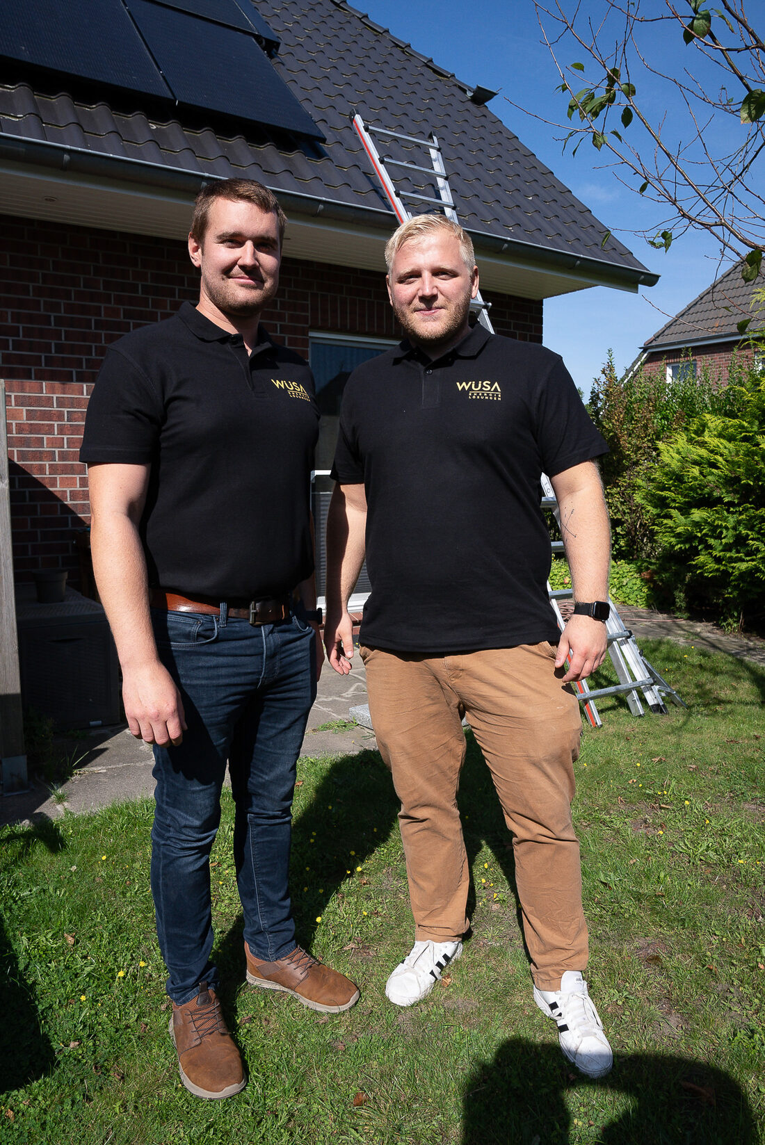 WÜSA Team vor einem Haus mit Solaranlage